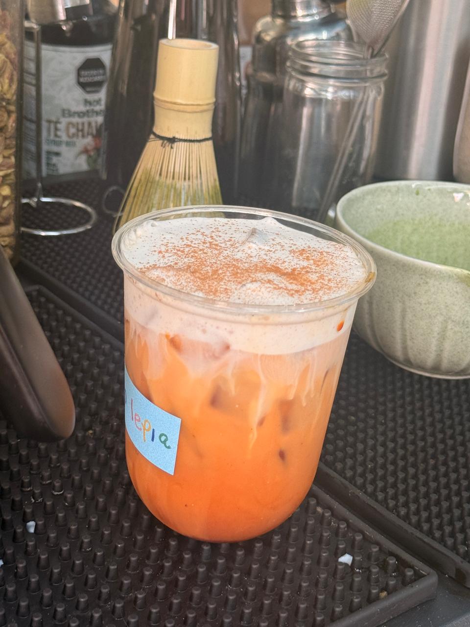 Orange iced drink with a cream top at the No Lepia bar