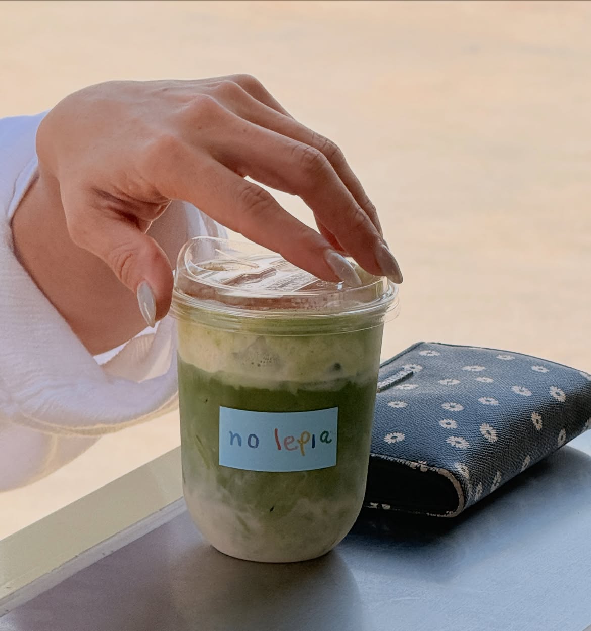Iced oat milk matcha latte in a no lepia cup
