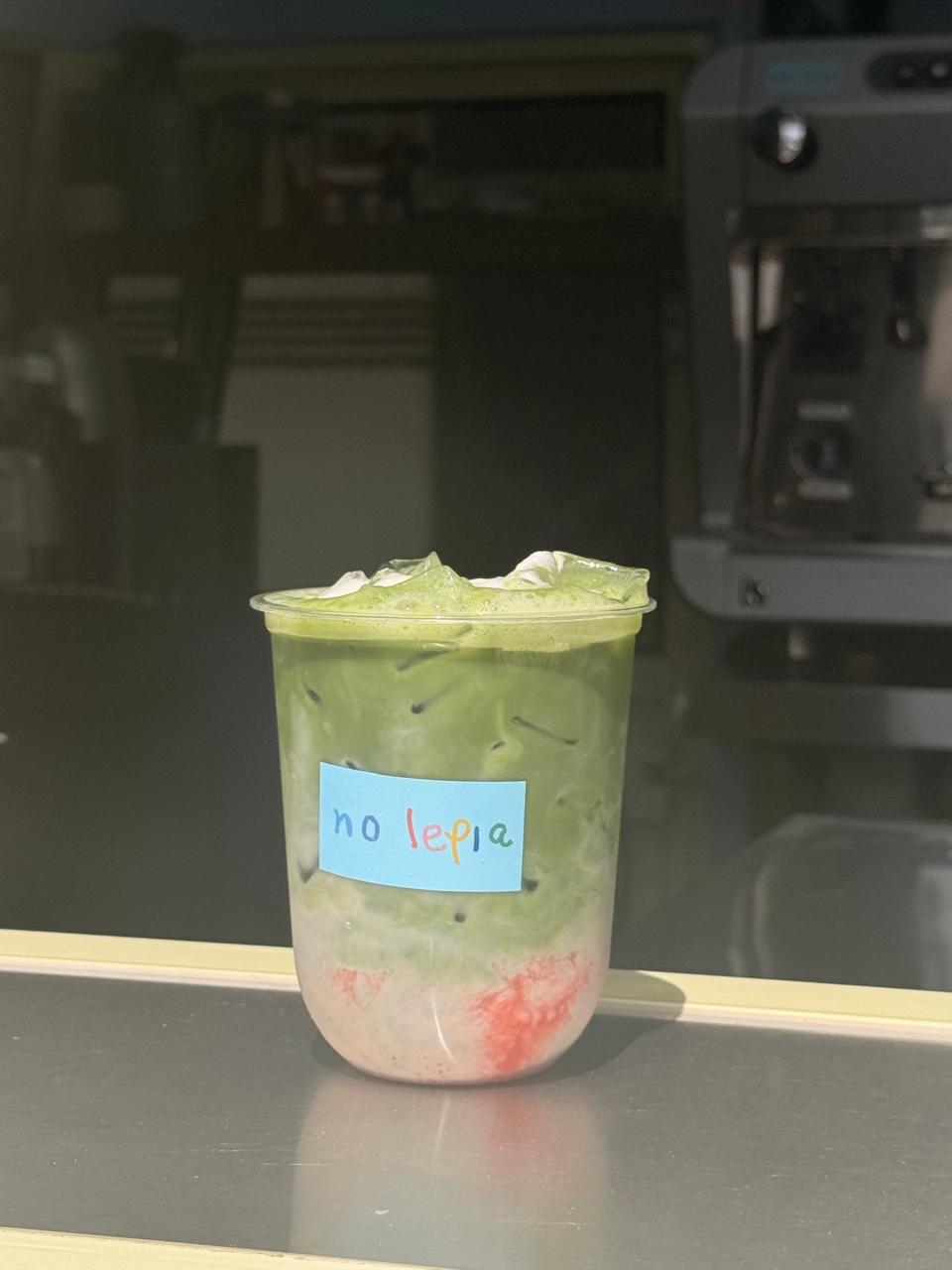 Creamy oat milk matcha iced latte with honey cinnamon cream top